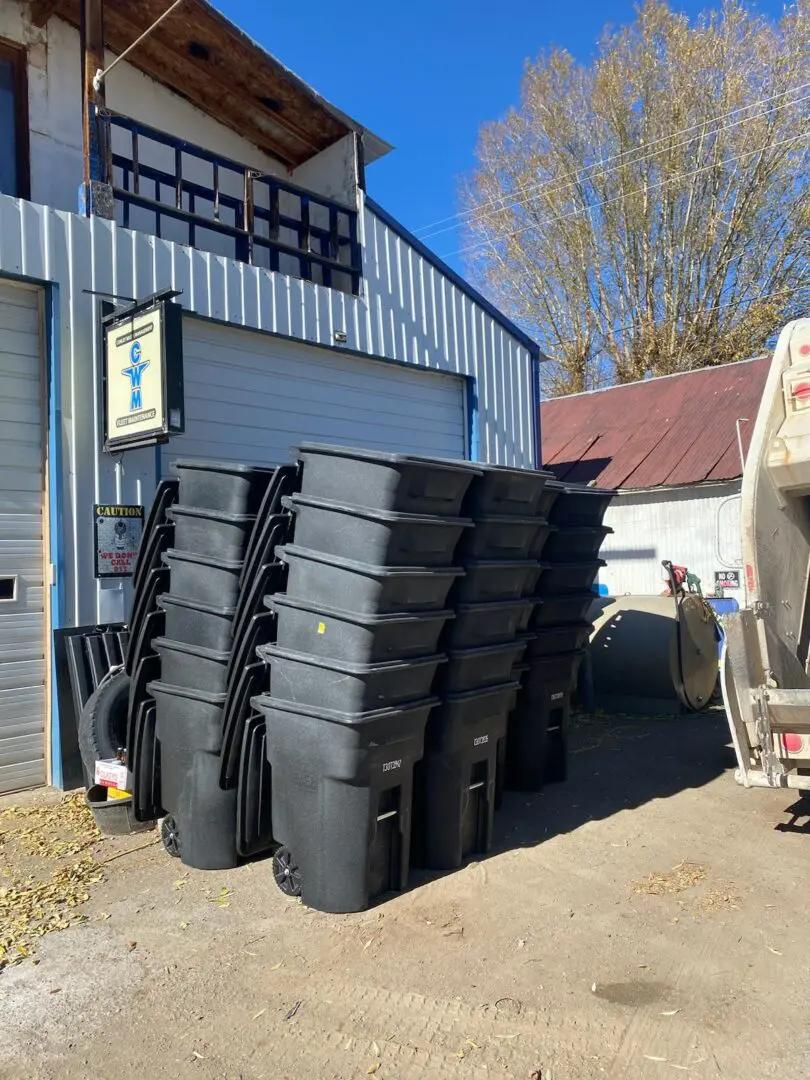 A group of black plastic containers sitting next to each other.