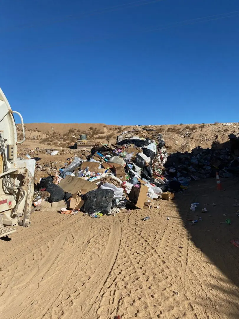 A dump truck is parked on the side of a hill.